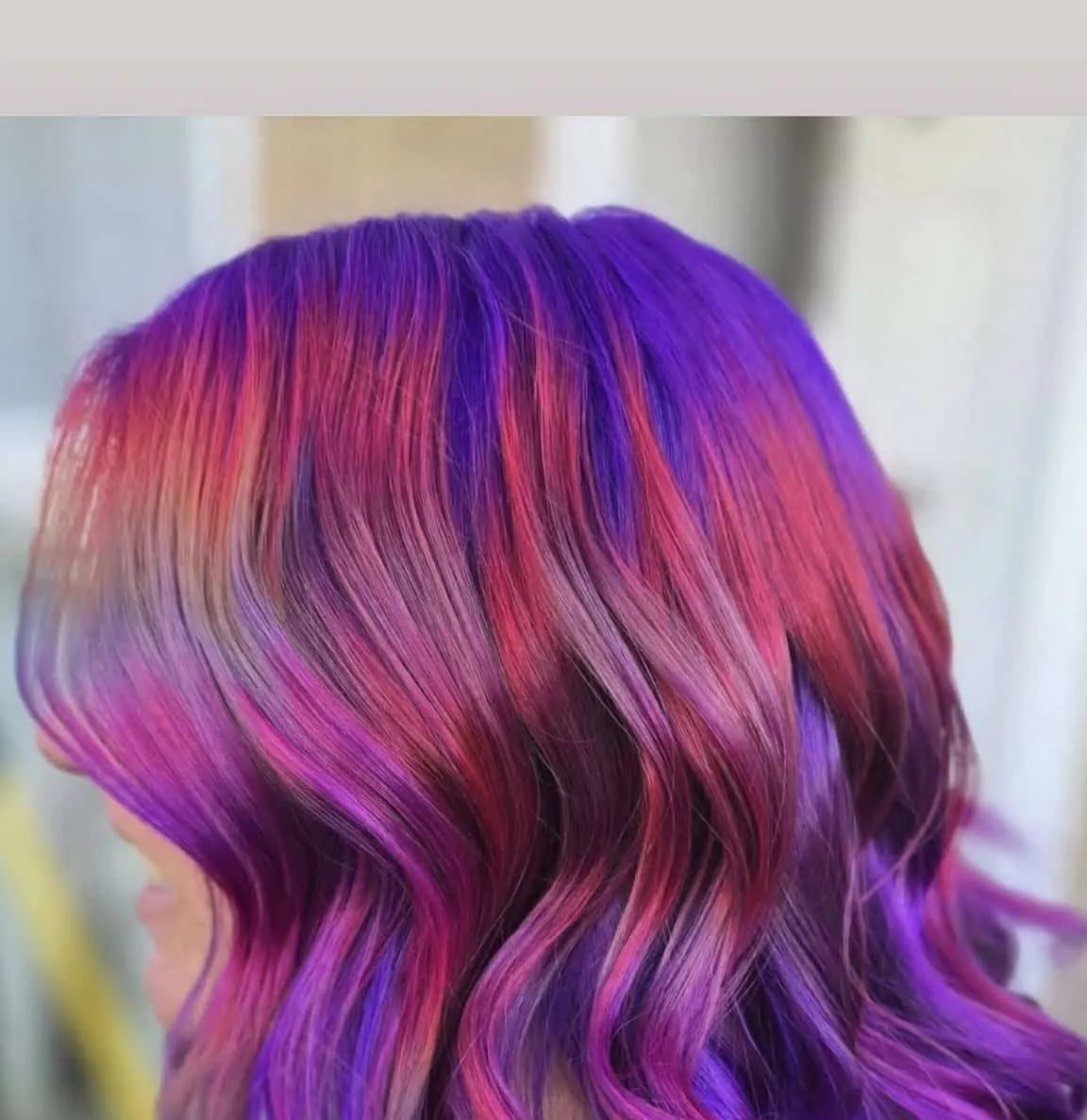 Purple and pink vivid colour, styled in loose waves